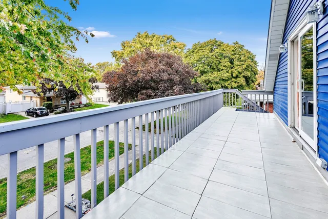 a view of a balcony with yard