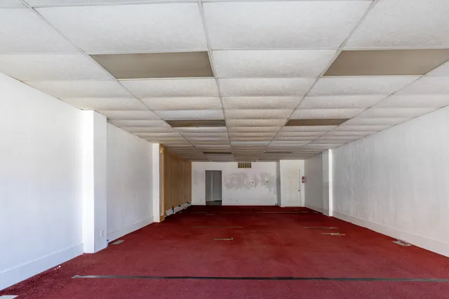 a living room with furniture and gym equipment