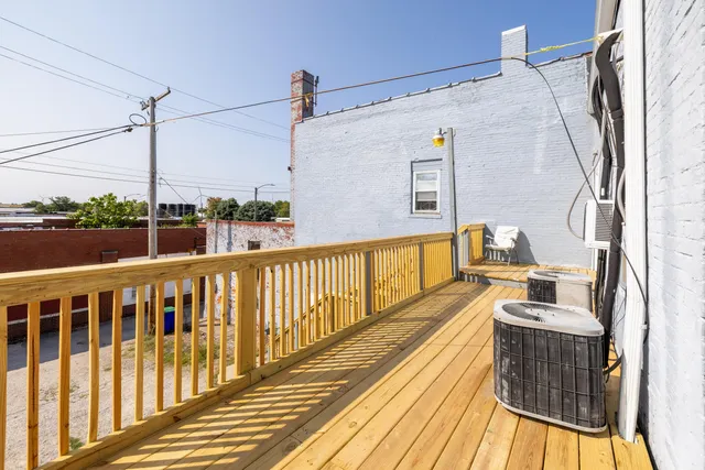 a view of balcony with wooden floor and outdoor seating
