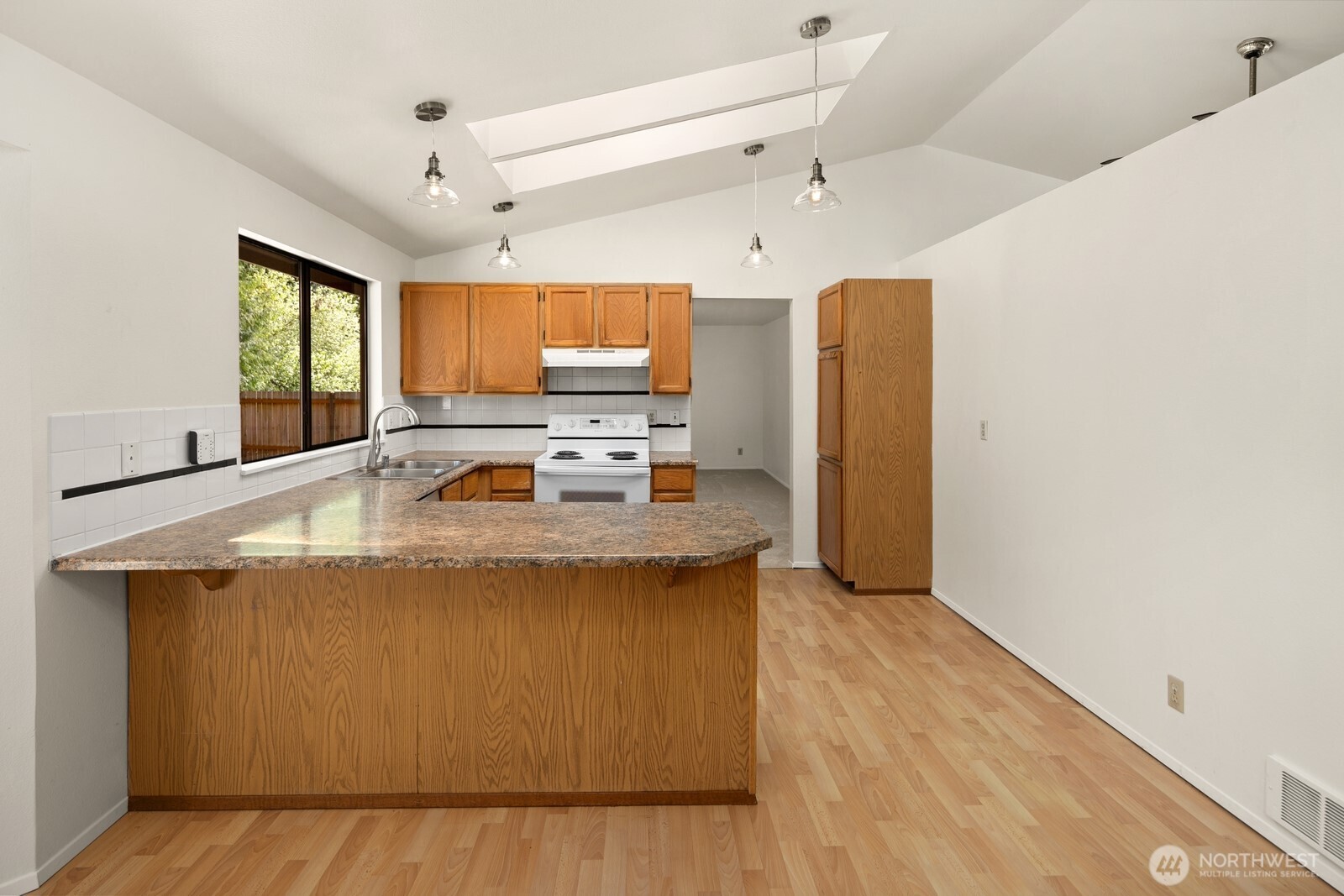 2831 166th Place Southeast Bothell, WA 98012 - Photo 17 of 25 a view of kitchen with stainless steel appliances granite countertop cabinets and wooden floor