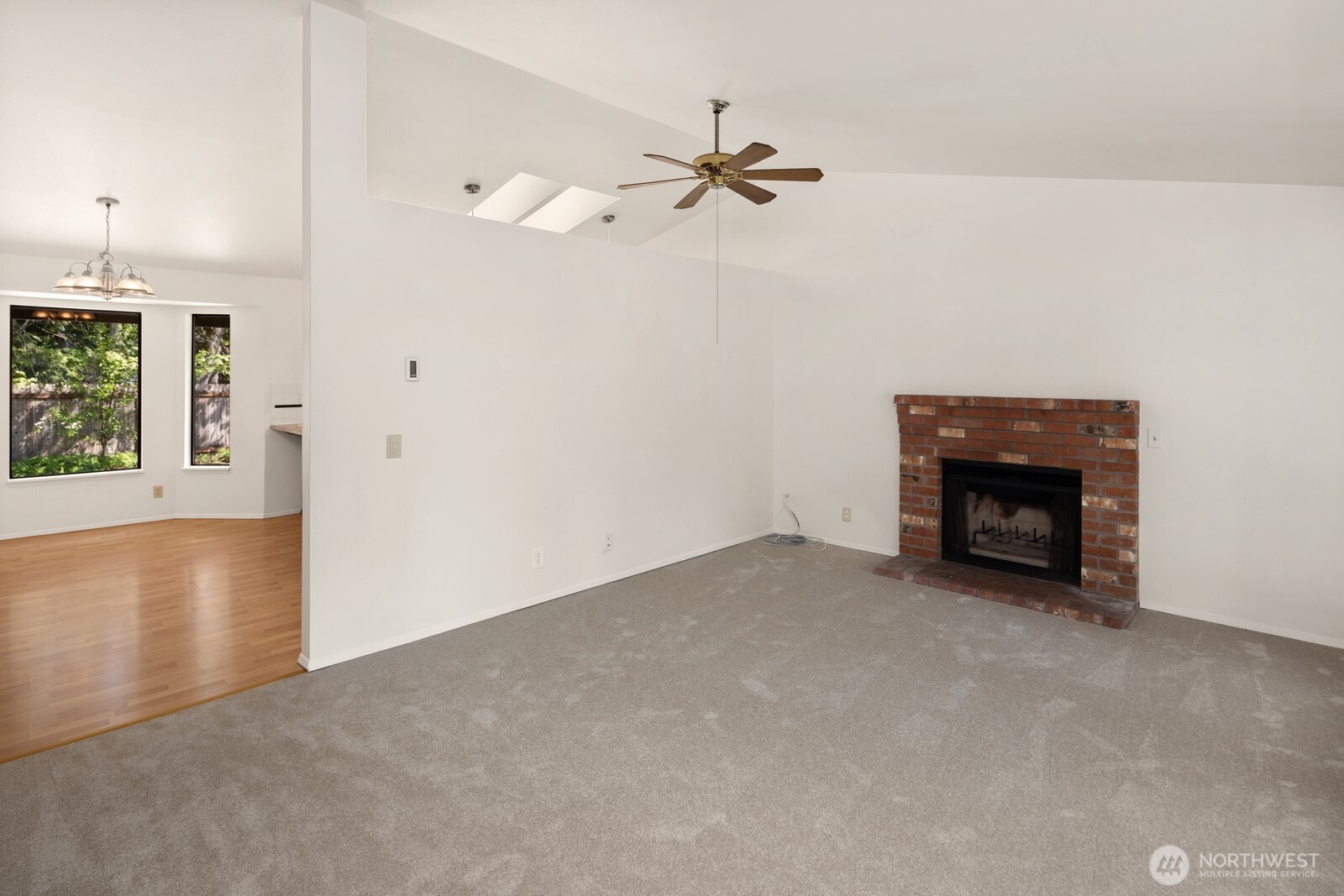 2831 166th Place Southeast Bothell, WA 98012 - Photo 23 of 25 an empty room with a fireplace and fan