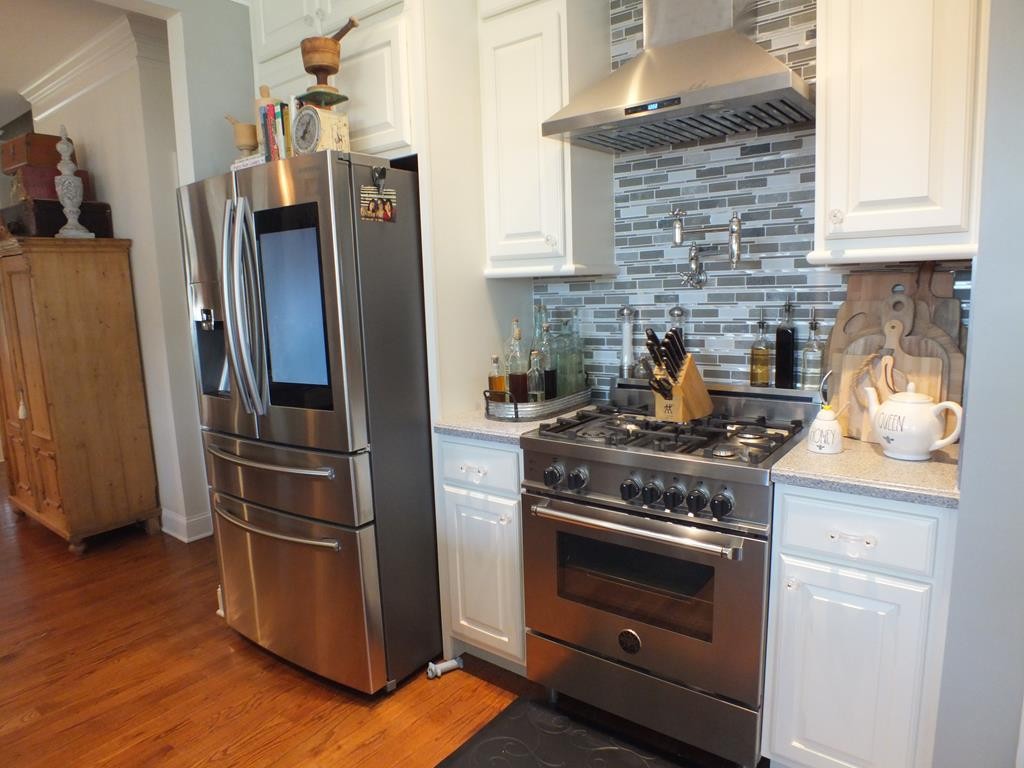 5641 Tucker Road Ooltewah, TN 37363 - Photo 23 of 53 a kitchen with stainless steel appliances granite countertop a stove and a refrigerator