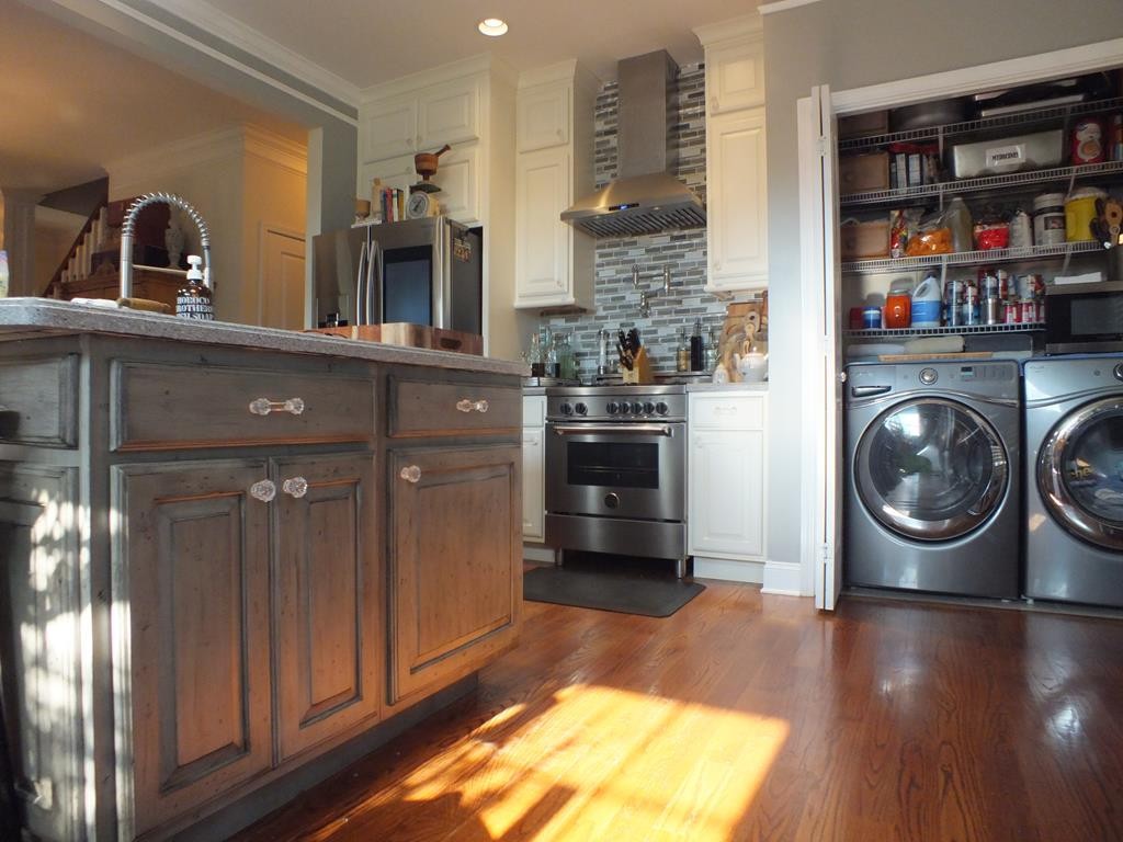 5641 Tucker Road Ooltewah, TN 37363 - Photo 26 of 53 a kitchen with microwave a stove and cabinets