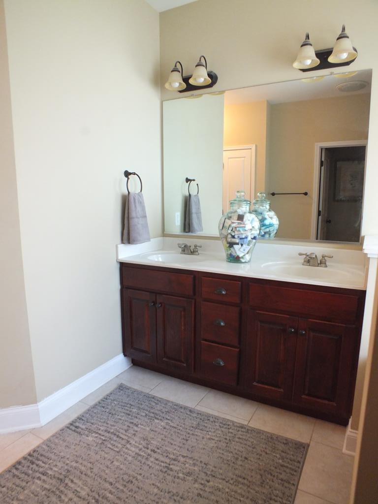 5641 Tucker Road Ooltewah, TN 37363 - Photo 35 of 53 a spacious bathroom with a granite countertop sink and a mirror