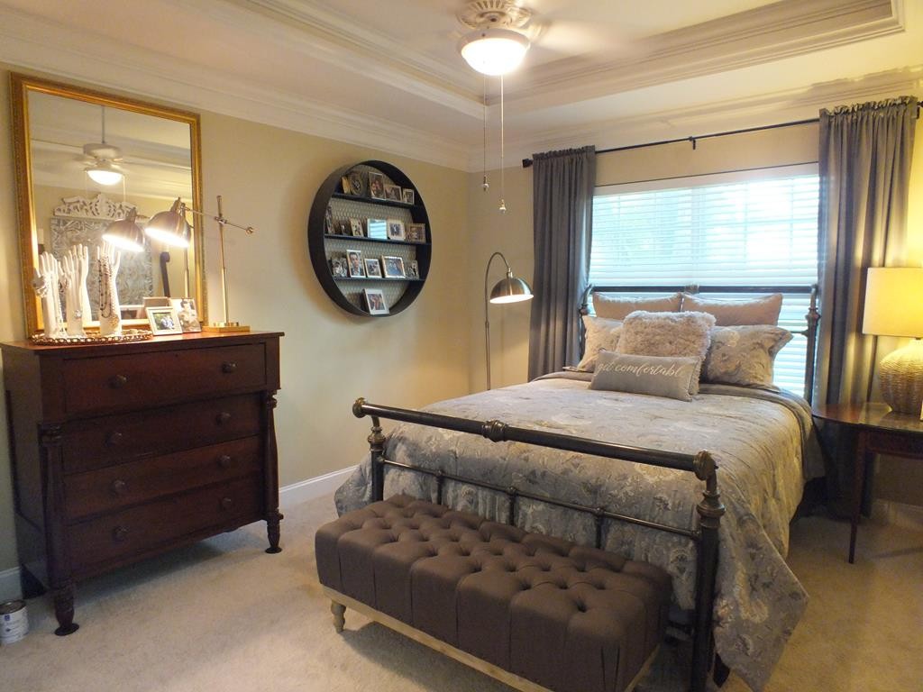 5641 Tucker Road Ooltewah, TN 37363 - Photo 36 of 53 a bedroom with a bed a mirror on dresser and a large window