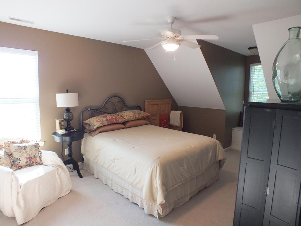 5641 Tucker Road Ooltewah, TN 37363 - Photo 37 of 53 a bedroom with a bed and a mirror
