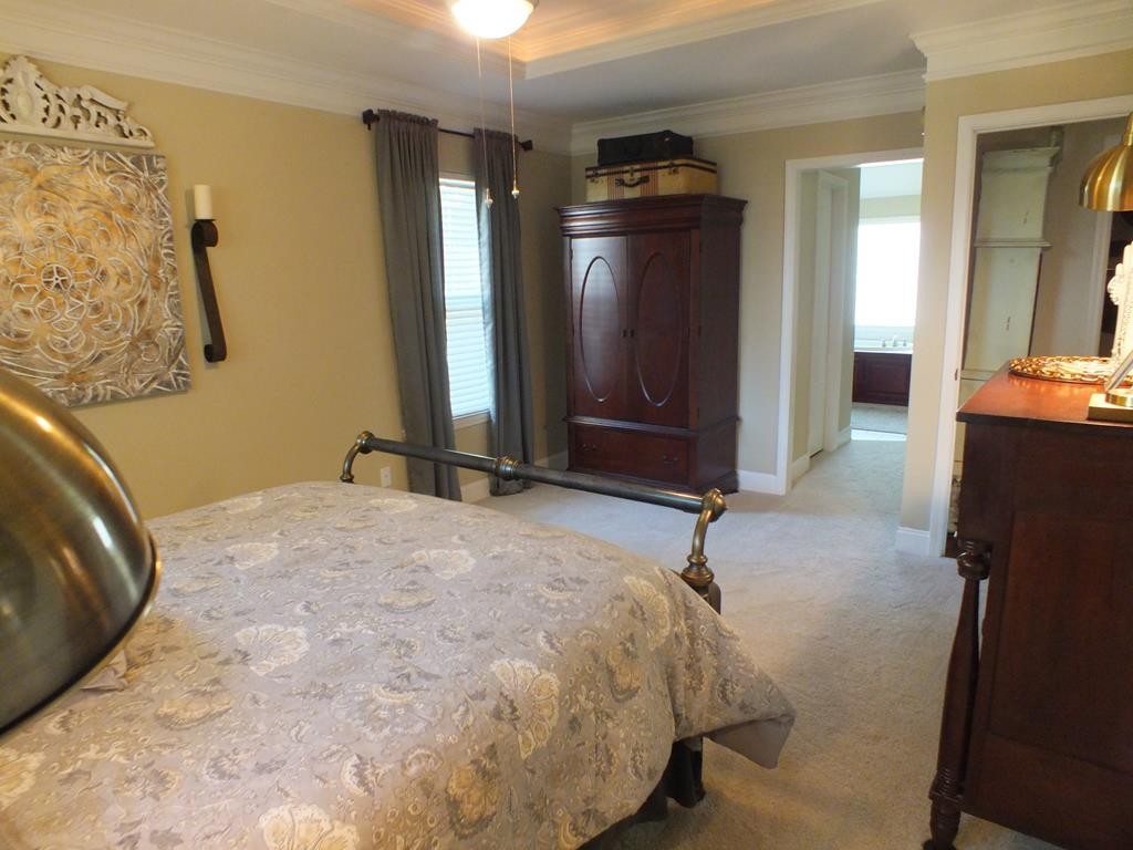 5641 Tucker Road Ooltewah, TN 37363 - Photo 43 of 53 a bedroom with a bed and a dresser