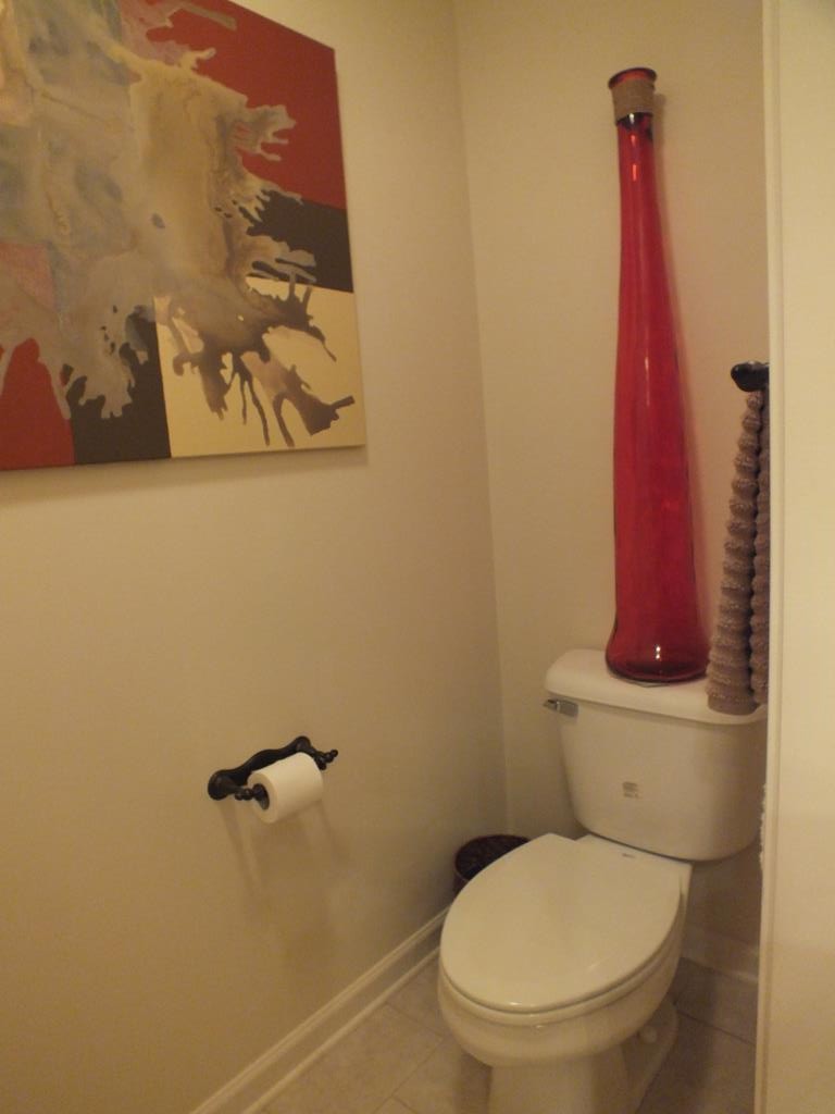 5641 Tucker Road Ooltewah, TN 37363 - Photo 46 of 53 a white toilet sitting next to a bathroom sink and vanity