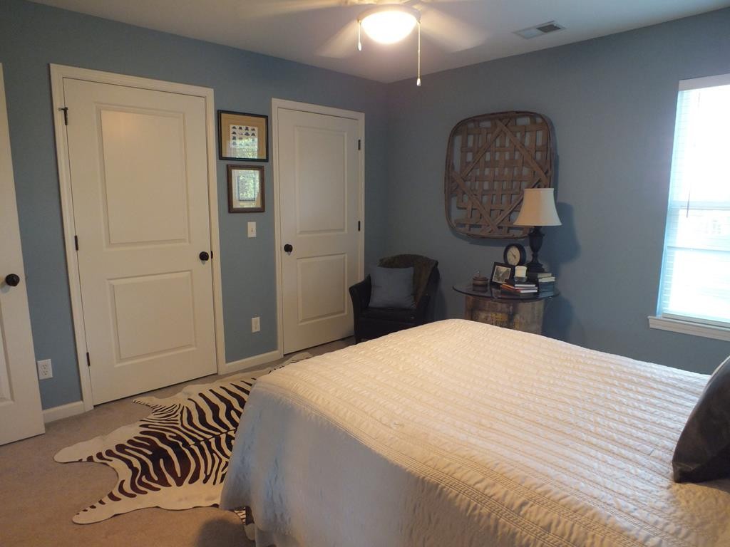5641 Tucker Road Ooltewah, TN 37363 - Photo 47 of 53 a bedroom with a bed and a chandelier