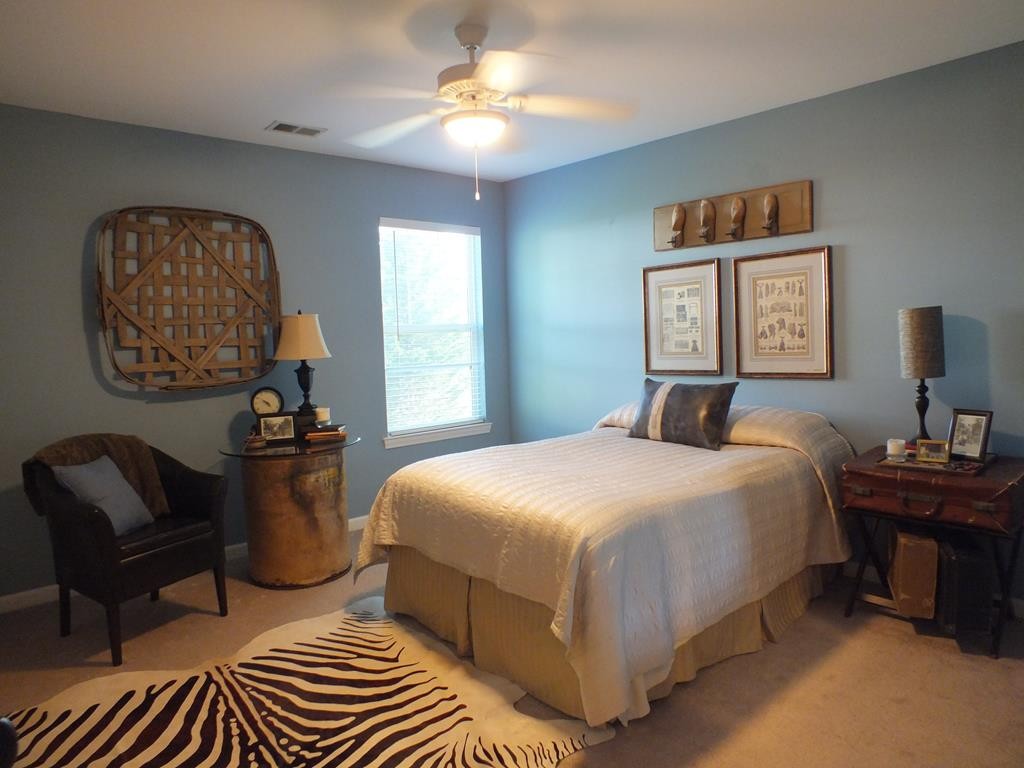 5641 Tucker Road Ooltewah, TN 37363 - Photo 48 of 53 a bedroom with a bed and a chandelier