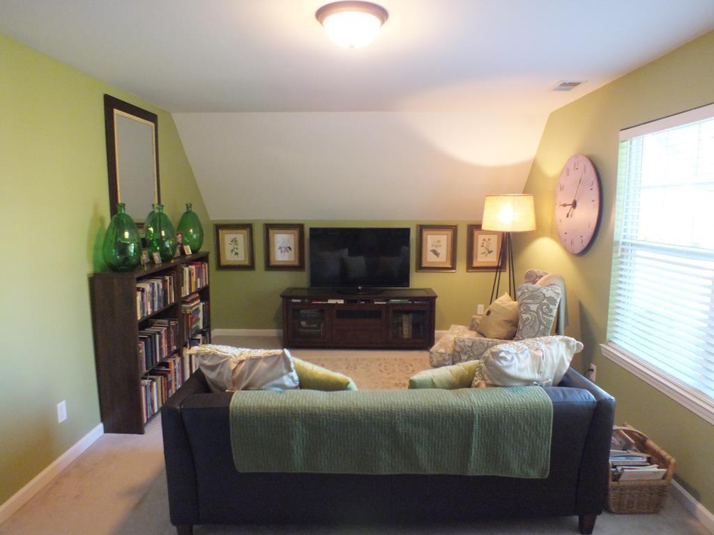 5641 Tucker Road Ooltewah, TN 37363 - Photo 53 of 53 a living room with furniture a flat screen tv and a large window