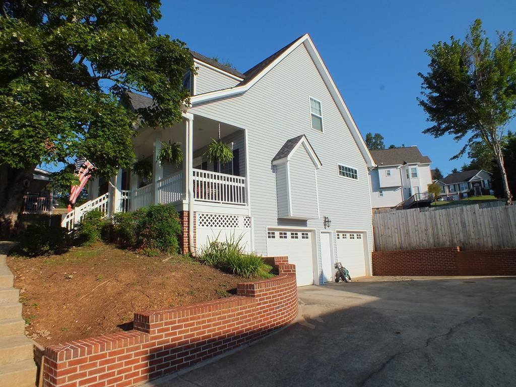 5641 Tucker Road Ooltewah, TN 37363 - Photo 9 of 53 a view of a white house with a yard and potted plants