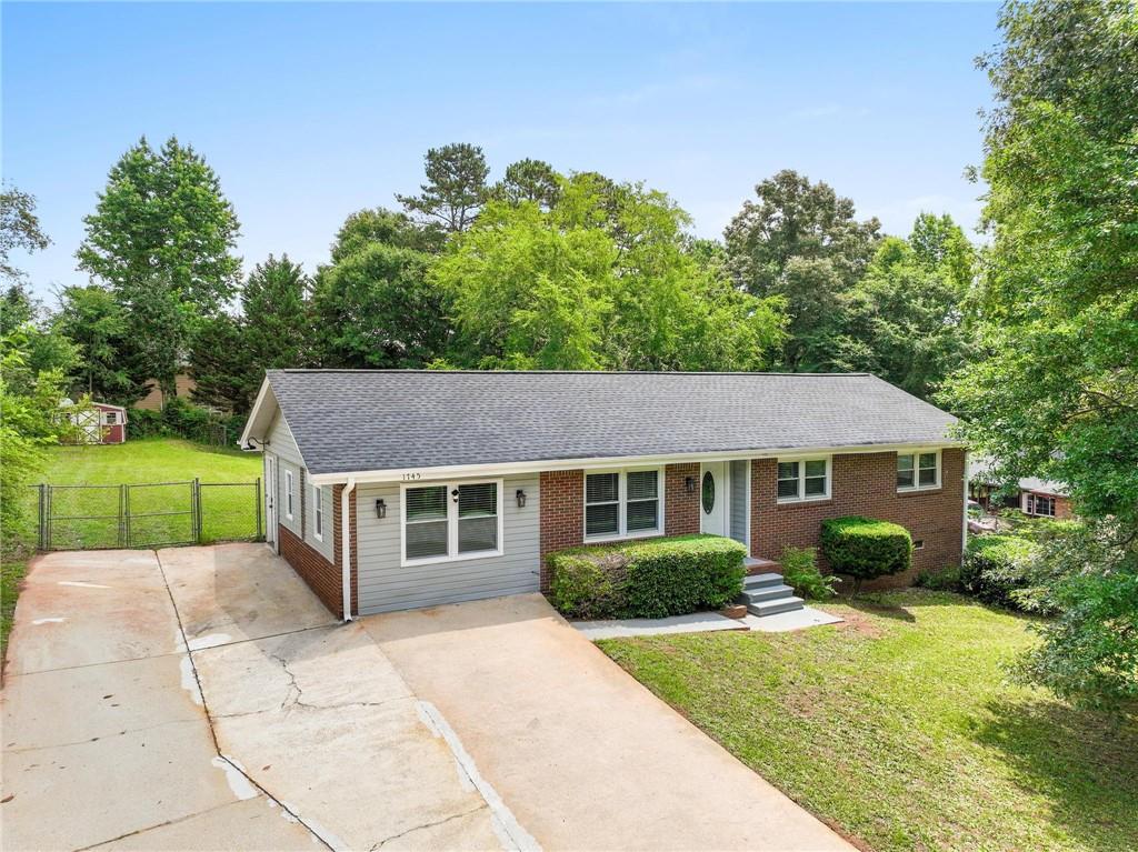 1745 Rockbridge Road Northwest Conyers, GA 30012 - Photo 32 of 32 a front view of a house with garden