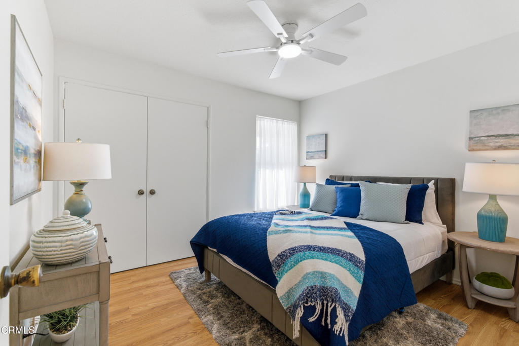 13151 Rose Street Cerritos, CA 90703 - Photo 13 of 24 a bedroom with a bed and a chandelier