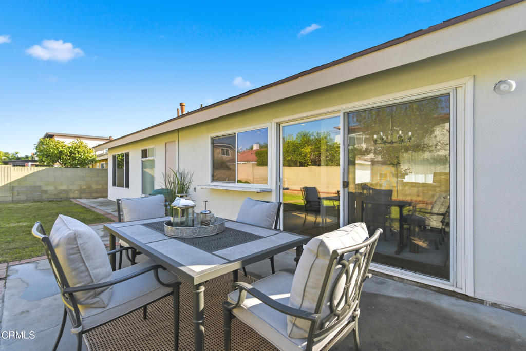13151 Rose Street Cerritos, CA 90703 - Photo 20 of 24 a view of a patio with a dining table and chairs