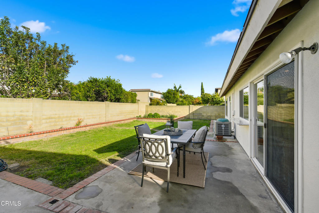 13151 Rose Street Cerritos, CA 90703 - Photo 21 of 24 a view of a patio with a table and chairs under an umbrella
