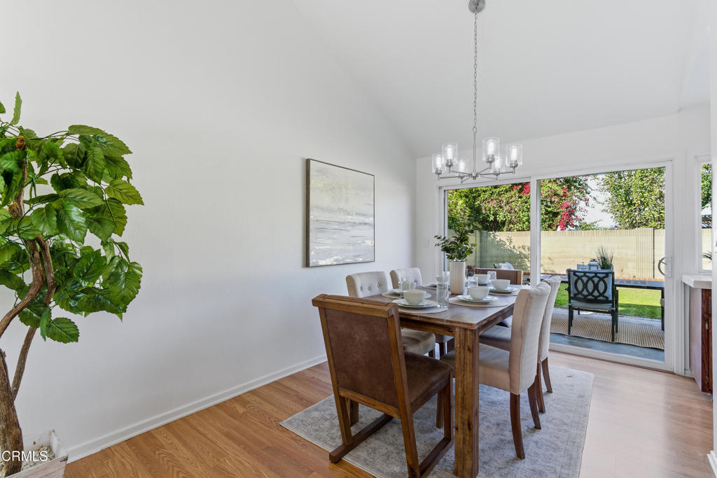 13151 Rose Street Cerritos, CA 90703 - Photo 7 of 24 a dining room with furniture a potted plant and a chandelier