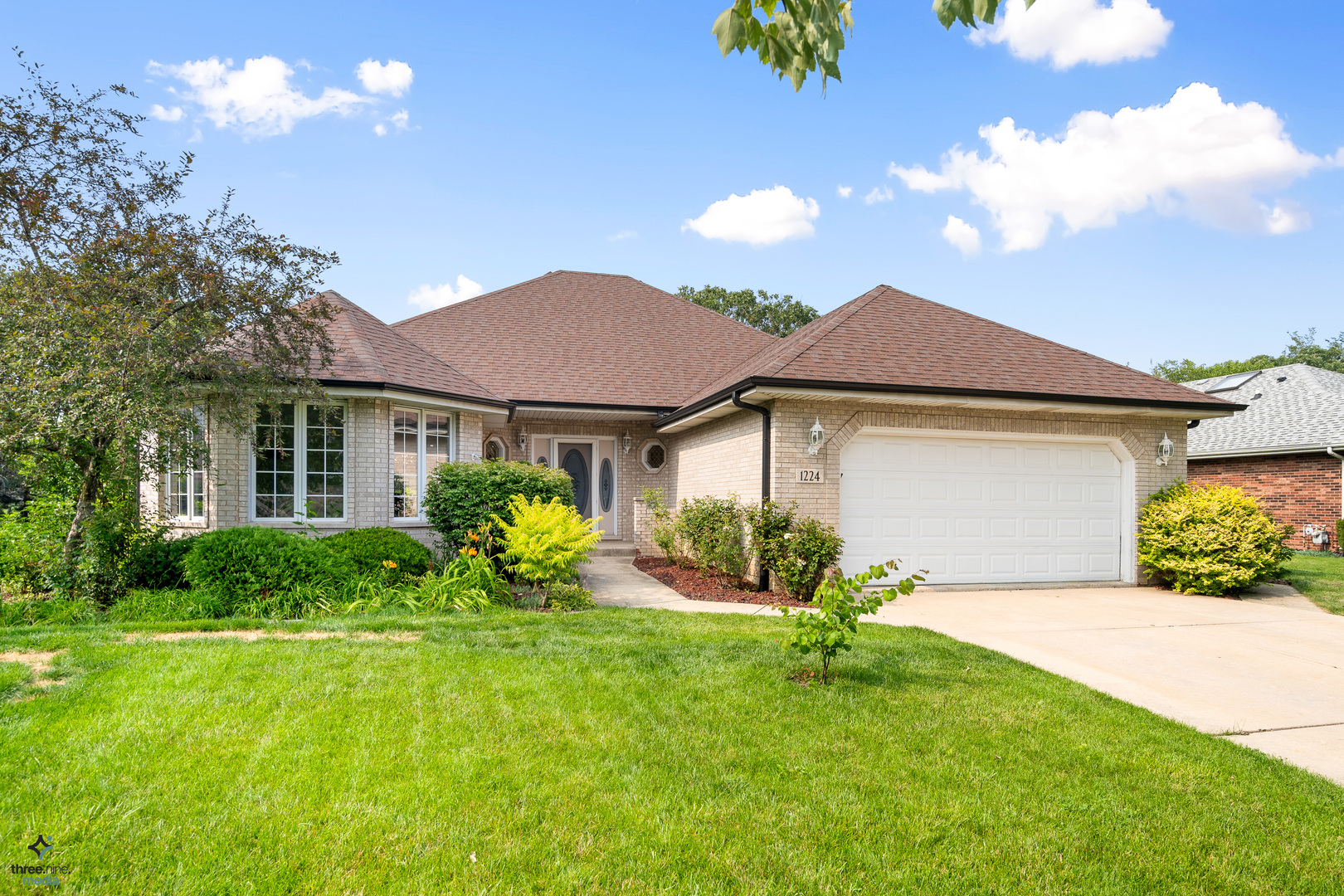 a view of a house with a yard and garden