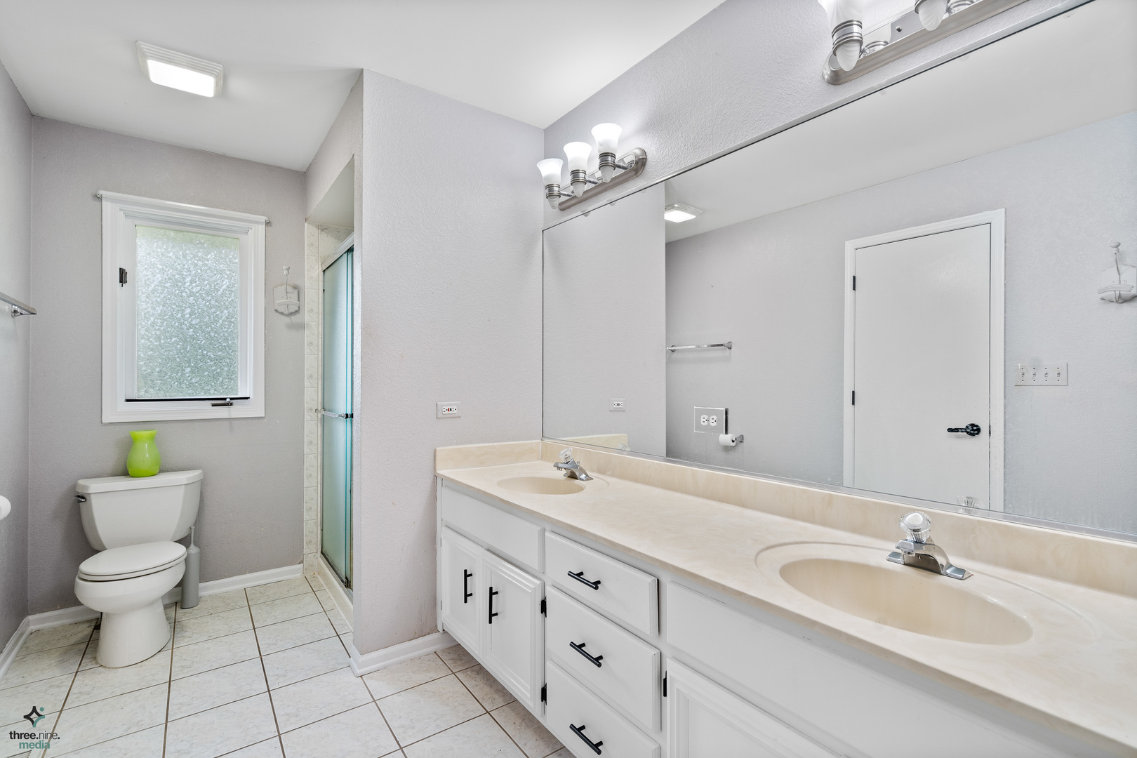 1224 Arbor Drive Lemont, IL 60439 - Photo 14 of 27 a spacious bathroom with a double vanity sink and a mirror