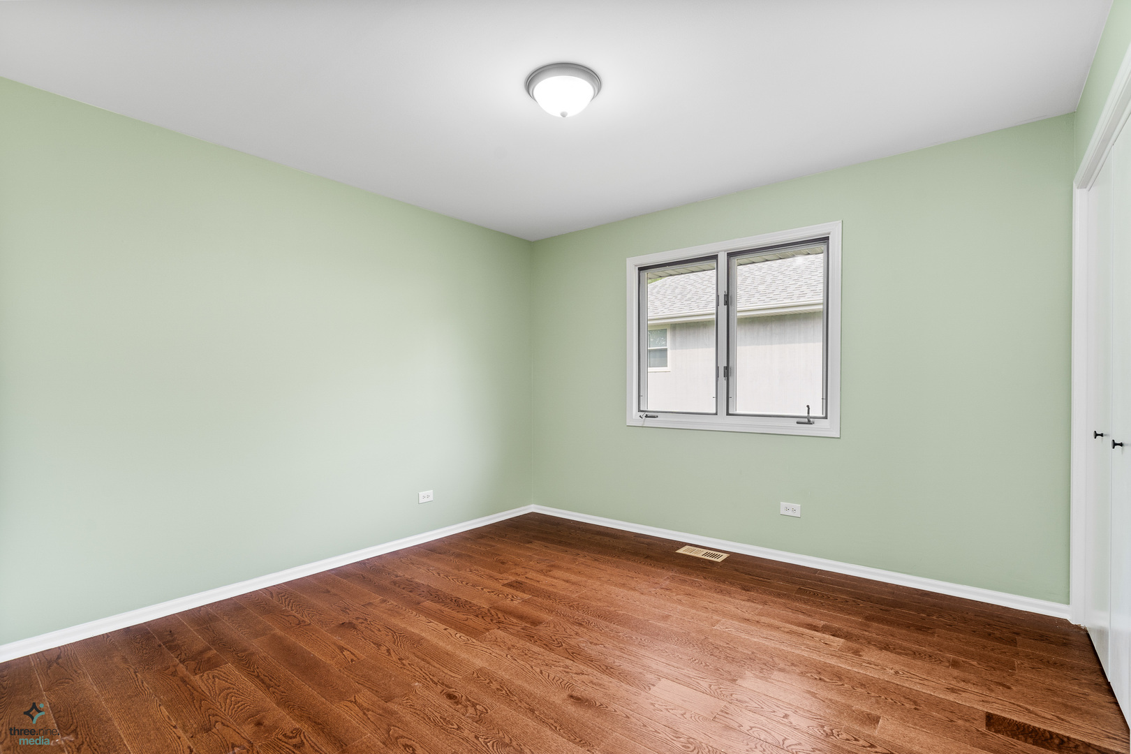 1224 Arbor Drive Lemont, IL 60439 - Photo 16 of 27 an empty room with wooden floor and windows