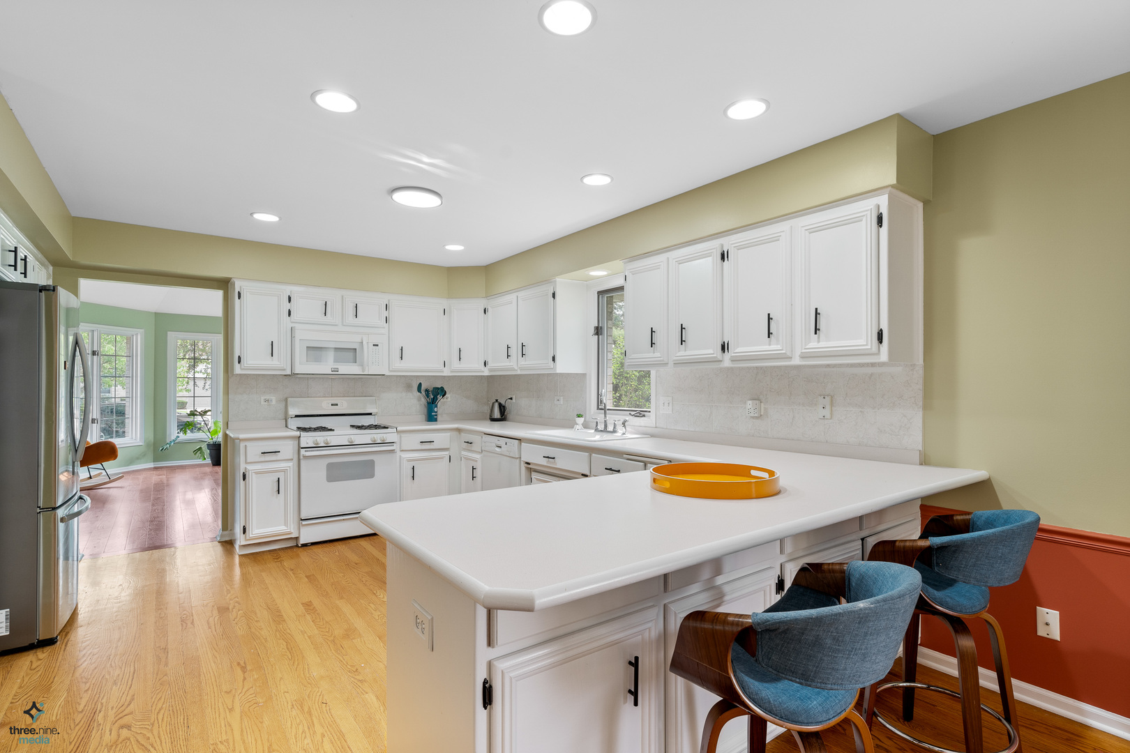 1224 Arbor Drive Lemont, IL 60439 - Photo 7 of 27 a kitchen with a stove a white table and chairs in it