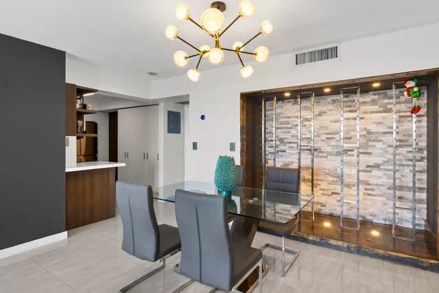 a view of a dining room with furniture and a chandelier fan