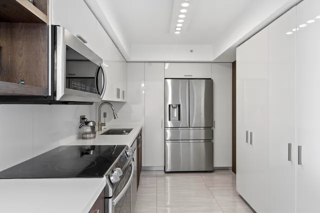 a kitchen with a sink stove and refrigerator
