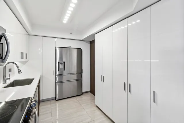 a kitchen with stainless steel appliances a refrigerator and a sink
