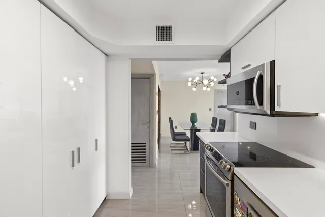a kitchen with a sink and a refrigerator