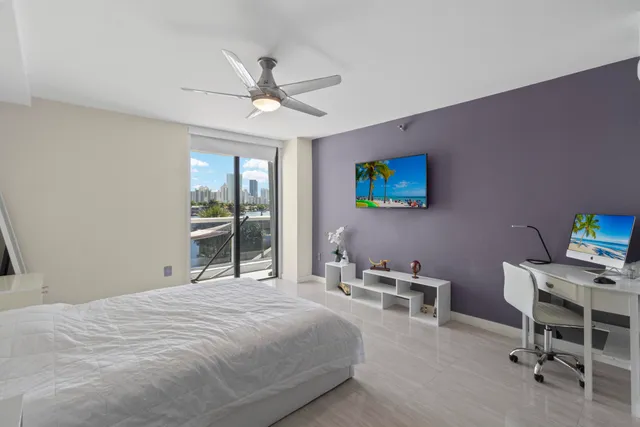 a bedroom with a bed a desk and chair