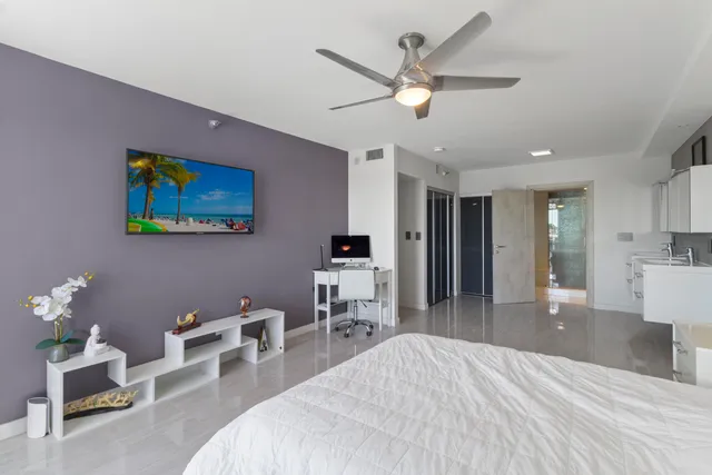 a bedroom with furniture and a large mirror