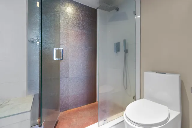 a white toilet sitting next to a bathroom sink