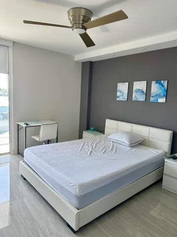 a bedroom with a bed and window