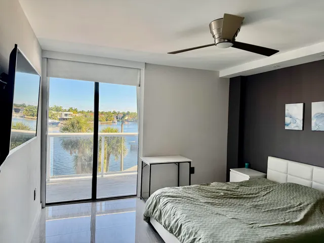 a bedroom with a large bed and a large window
