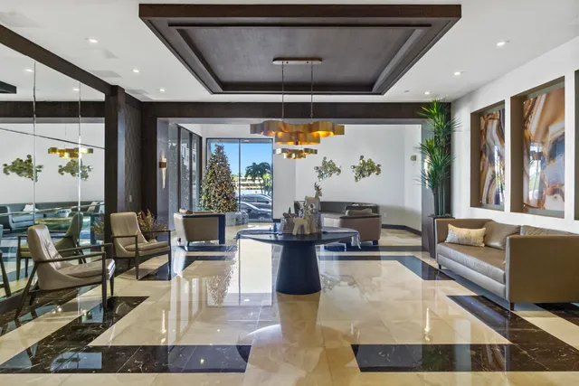 a living room with fireplace furniture and a large window