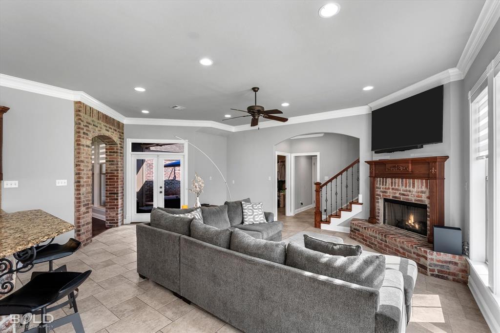 2220 Forest Hills Boulevard Haughton, LA 71037 - Photo 24 of 40 Living area featuring a brick fireplace with a wood mantel, recessed lighting, and a ceiling fan