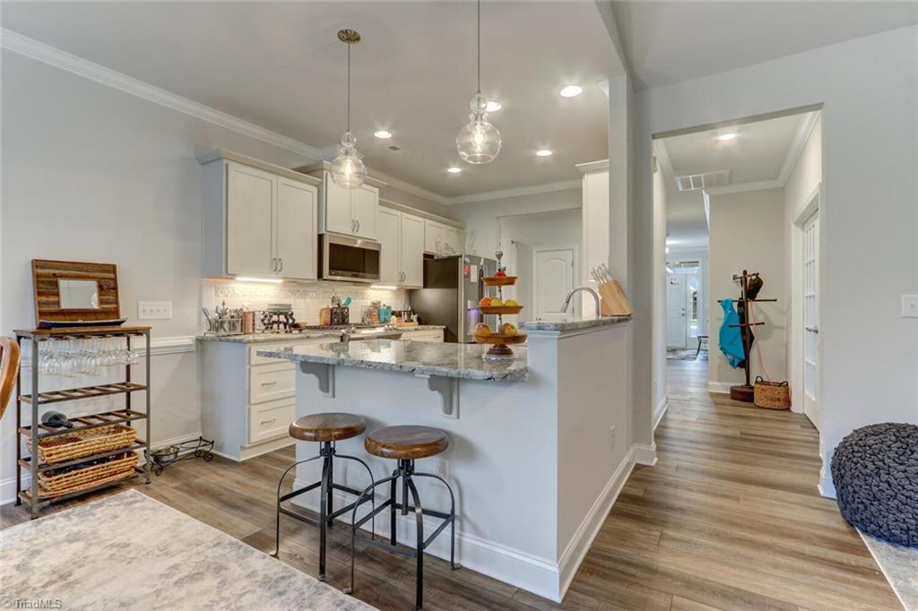 6526 Marion Gibson Way Oak Ridge, NC 27310 - Photo 9 of 27 SEATING BAR AT KITCHEN