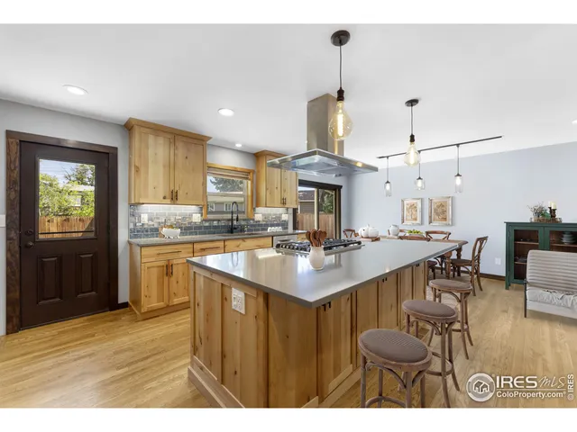 a kitchen with a sink cabinets and wooden floor