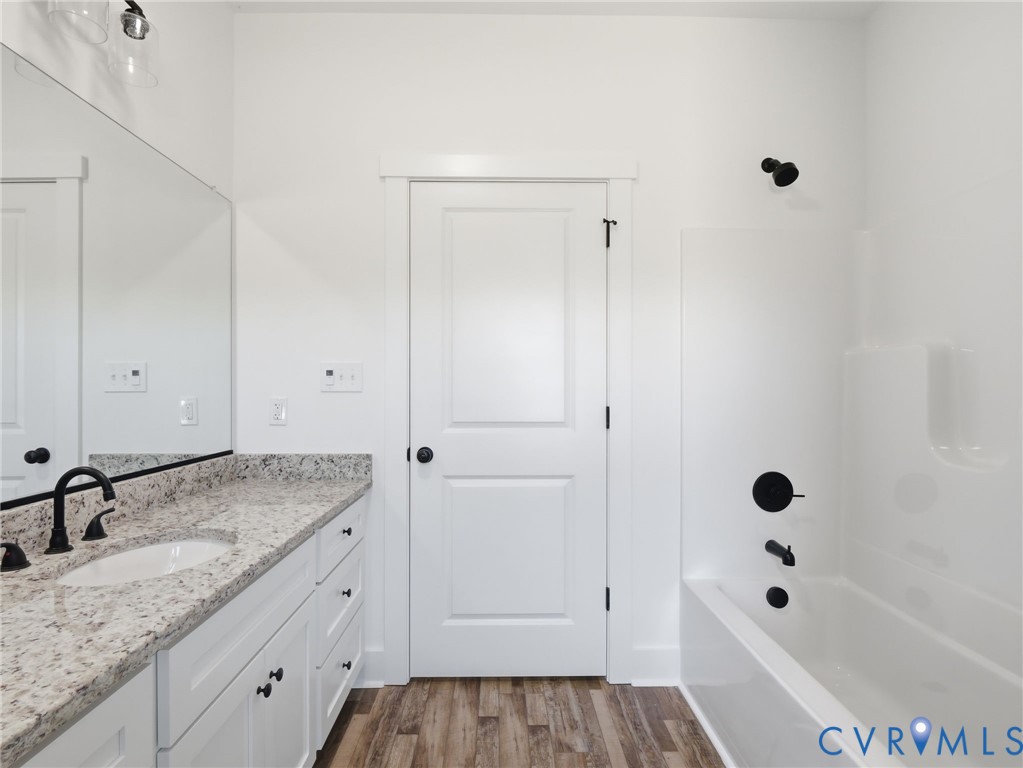 3706 Broad St Road Gum Spring, VA 23065 - Photo 20 of 34 a bathroom with a granite countertop tub sink and mirror