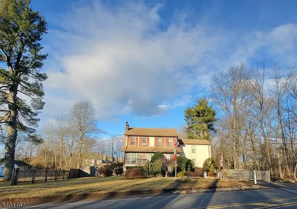 a view of a house with a yard covered in snow