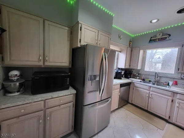 a kitchen with a sink stove and refrigerator