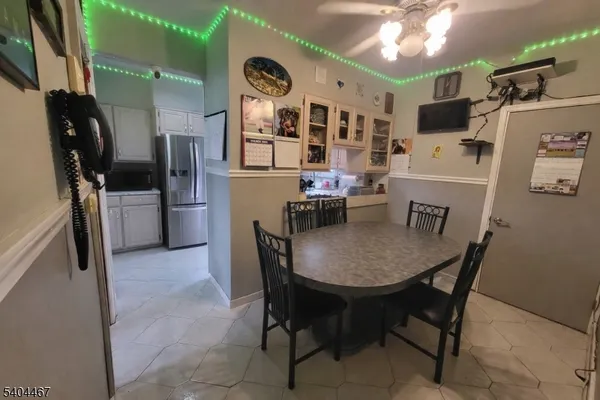a view of a dining room with furniture and a chandelier