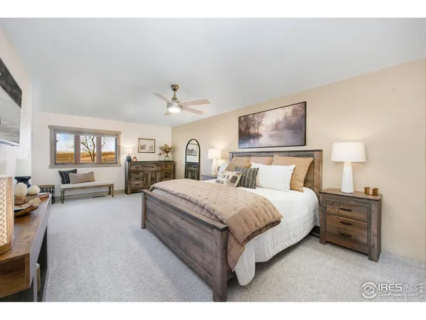 a spacious bedroom with a large bed and a chandelier