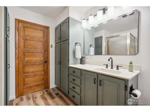a bathroom with a double vanity sink a mirror and a shower