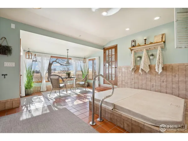 a living room with furniture a table and wooden floor