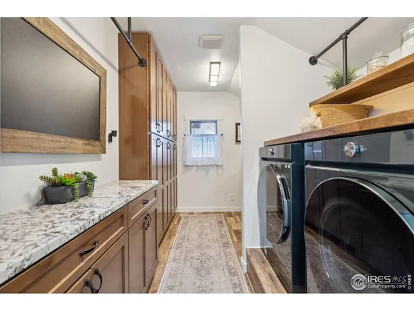 a bathroom with a granite countertop sink a washer and dryer