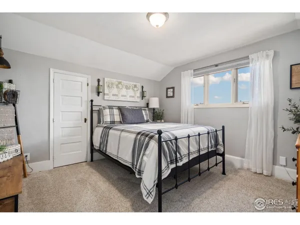 a bed room with a bed and a window