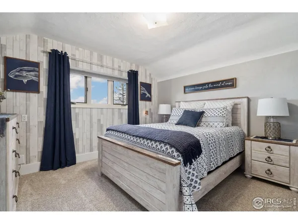 a bedroom with a bed and a painting on the wall