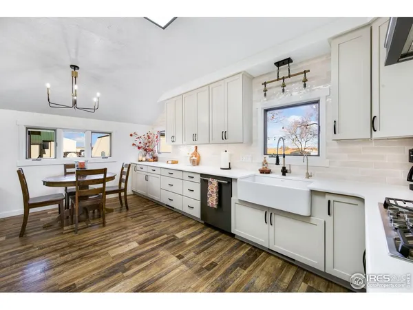 a kitchen with a sink cabinets and wooden floor