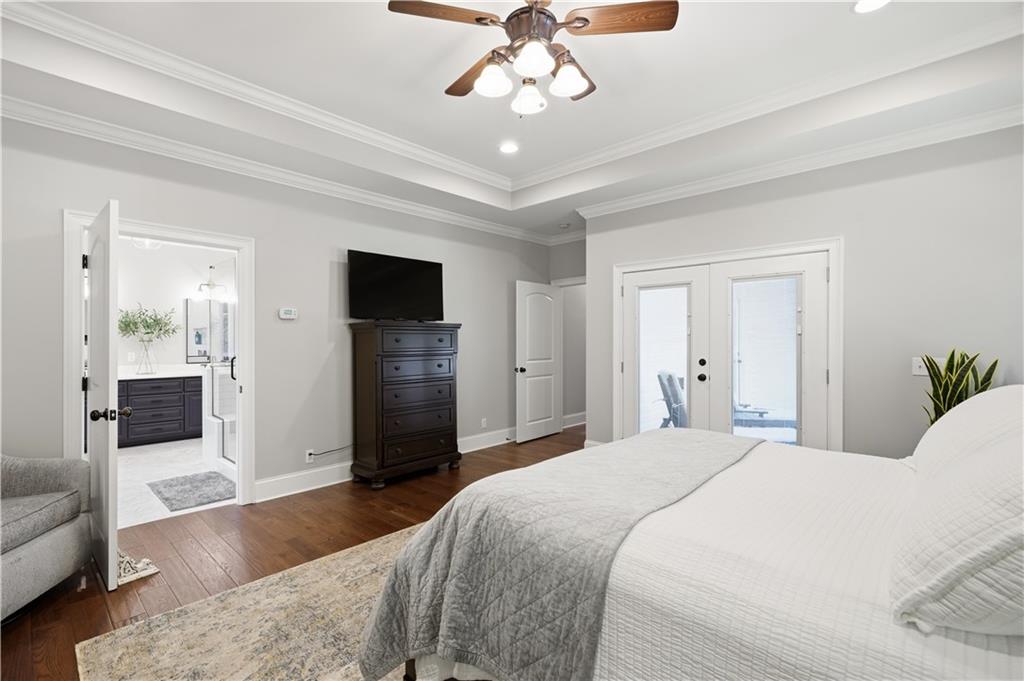 310 Gaines Road Southeast Dalton, GA 30721 - Photo 22 of 53 a bedroom with a bed ceiling fan and a wooden floor